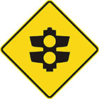 yellow diamond-shaped sign with black icon of traffic lights with only 2 lamps