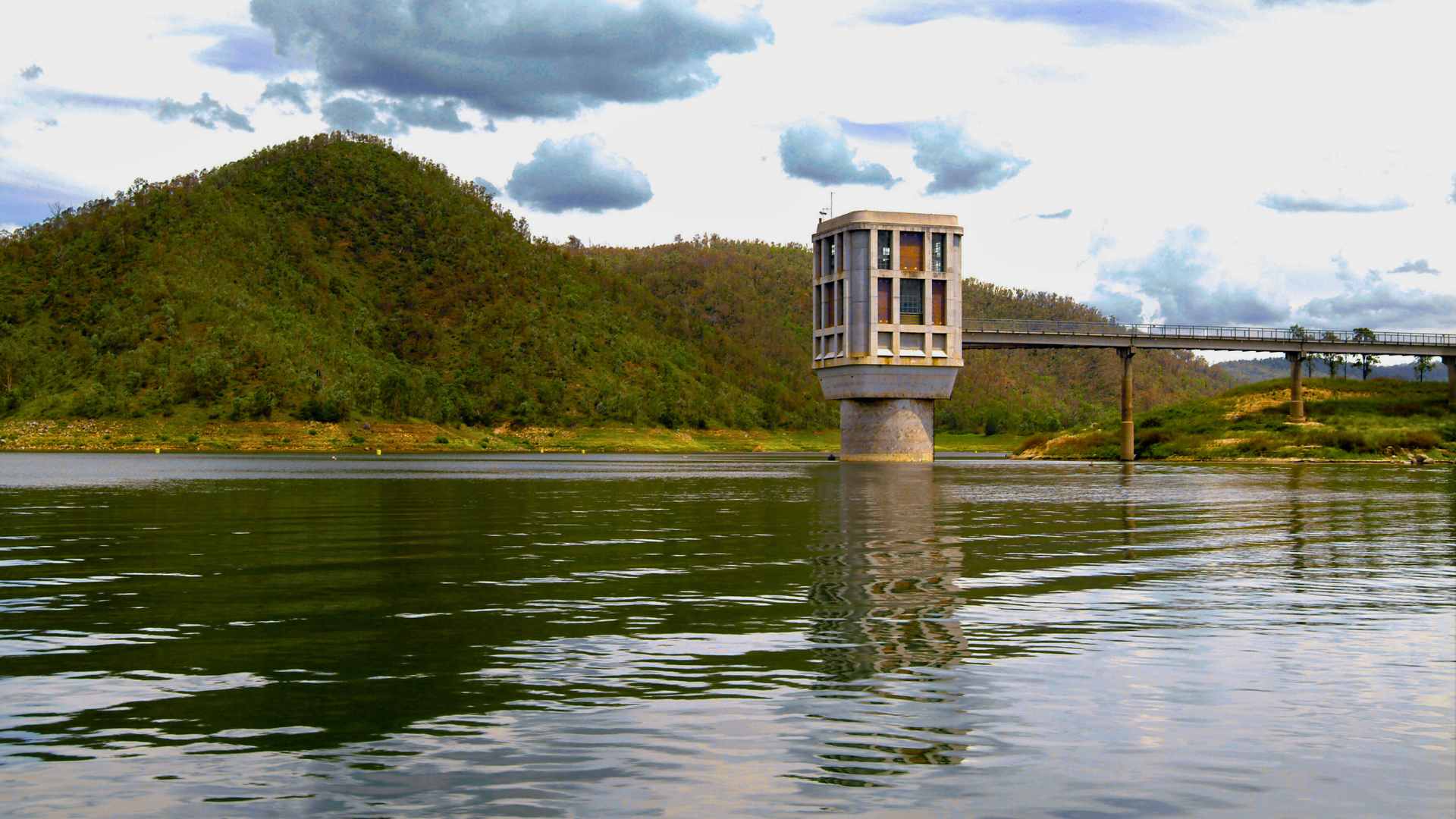 Reservoir with steep surrounding hills and clear open water.