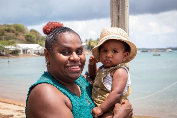 Thursday Island parent holding a child.