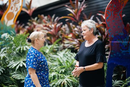 Two women in a garden chatting