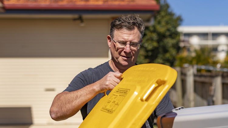 Person opening rubbish bin