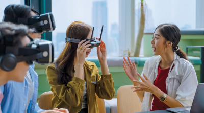 Two young women trying on virtual reality glasses.