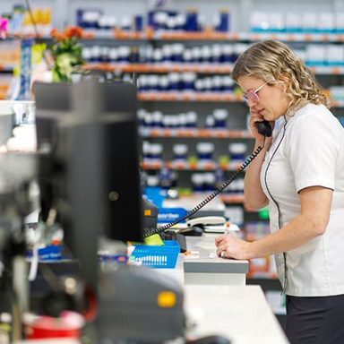 A pharmacist talking on the phone