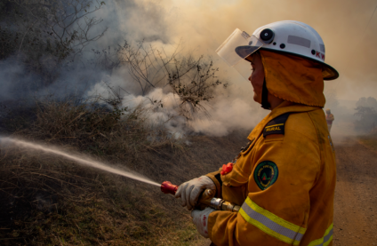 Photo of an officer spraying water from a fire hose