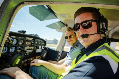 Two male pilots sitting in a cockpit