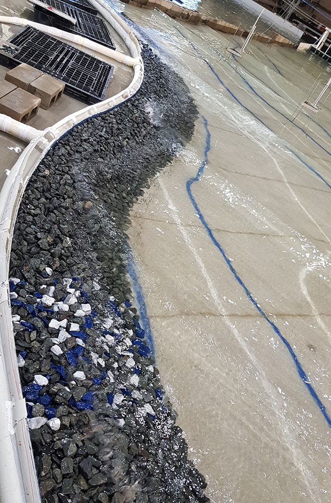 Graded rocks used in the basin to test overtopping and structural stability of a seawall design.
