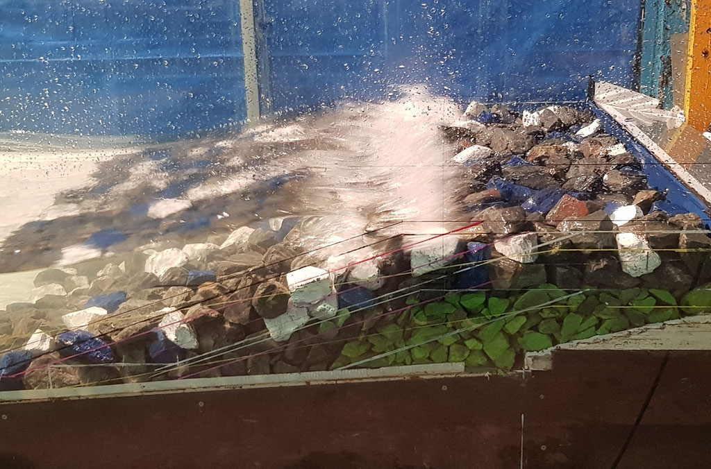 Graded rocks used to test seawall stability and overtopping against design wave and water level conditions.