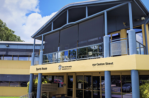 Exterior shot of the Sports House Milton building showing both storeys and signs with the building name and address on the first level