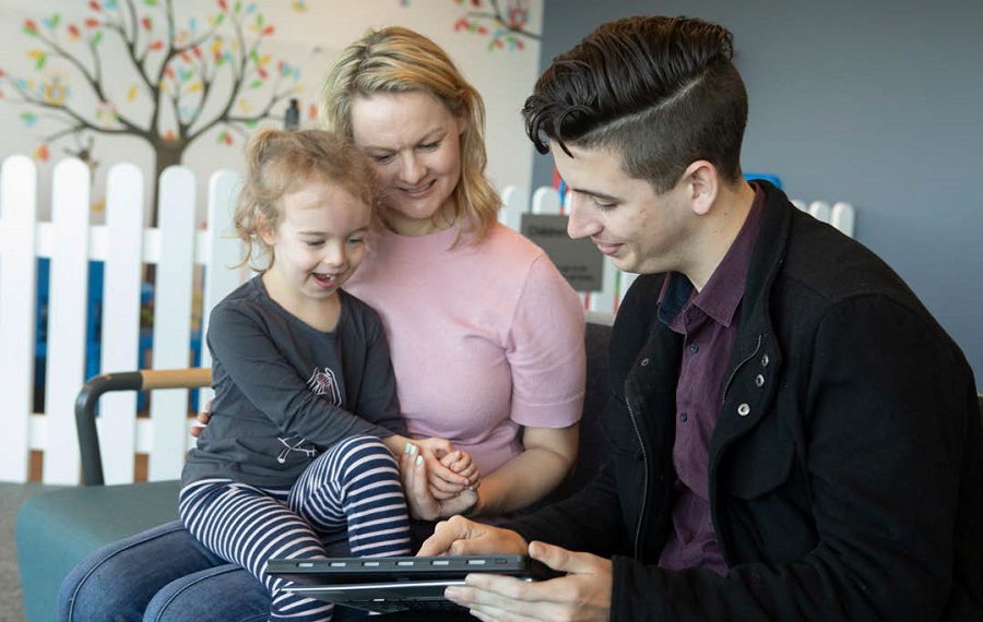 A family interacts with a tablet device together