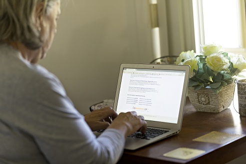 person sitting at a desk looking at a computer