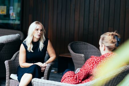 Two women seated in conversation